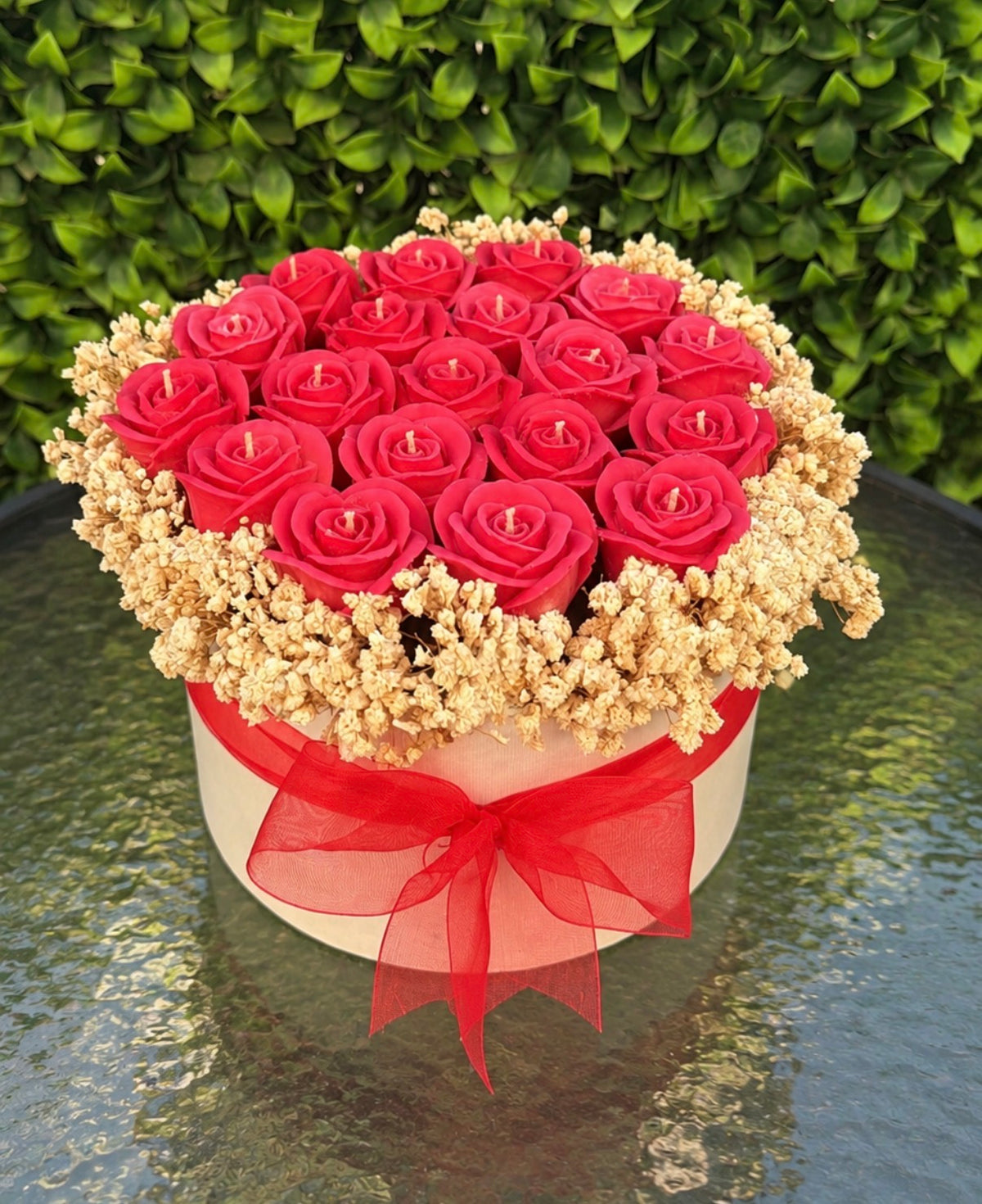 Red wax roses with baby's breath in a hat box with red organza bow by Missy Sol