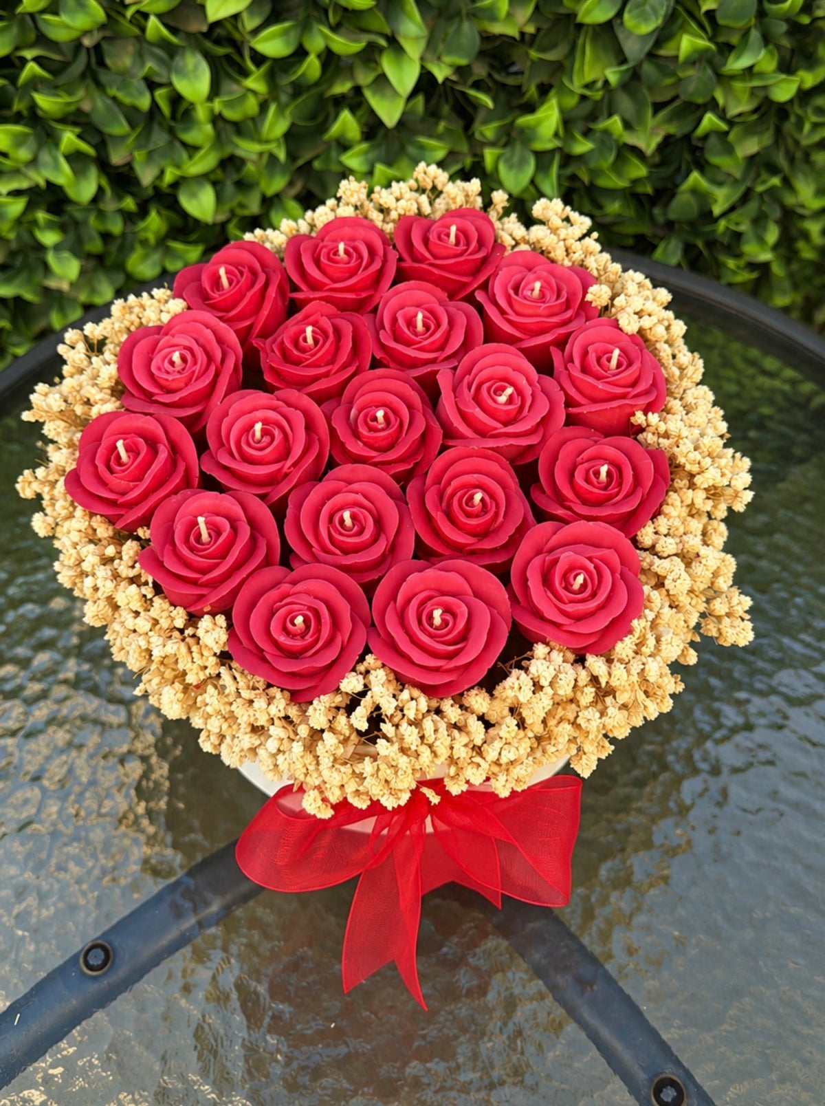 Wrapped bouquet of red wax roses with baby's breath by Missy Sol